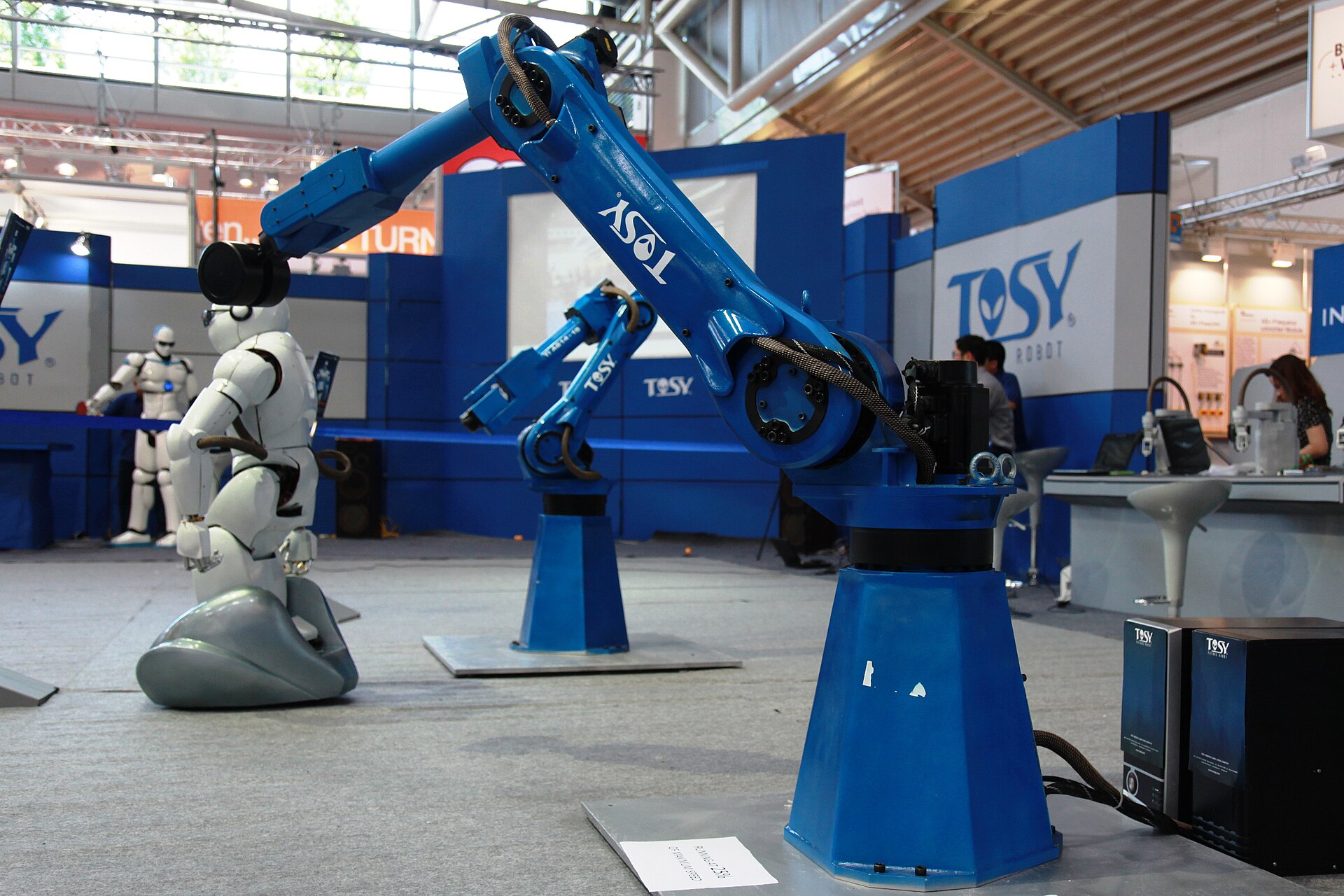 An industrial robotic arm, illustrating software agents that operate tools on their own